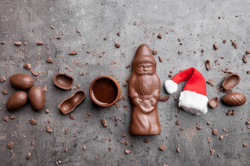 Delicious festive Christmas chocolate and sweets on rustic background