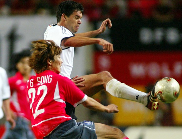 Germany's Michael Ballack, right, is challenged by South Korea's Song Chong Gug, during the 2002 World Cup semifinal match between Germany and South Korea, at the Seoul World Cup stadium in Seoul, Sou ...