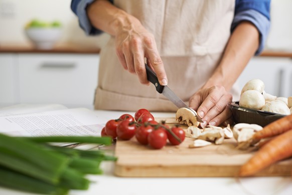 Cropped shot of a young woman chopping vegetables