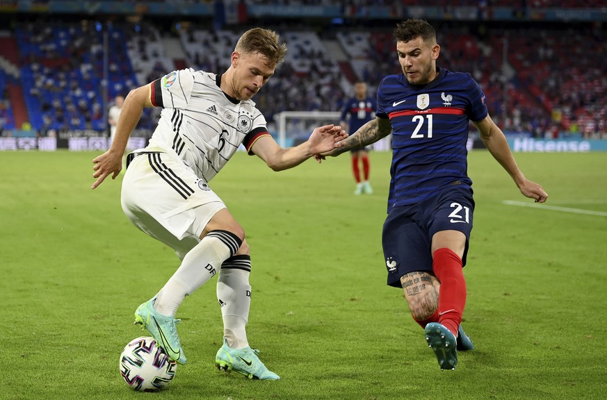 Germany&#039;s Joshua Kimmich, left, and France&#039;s Lucas Hernandez challenge for the ball during the Euro 2020 soccer championship group F match between France and Germany at the Allianz Arena sta ...