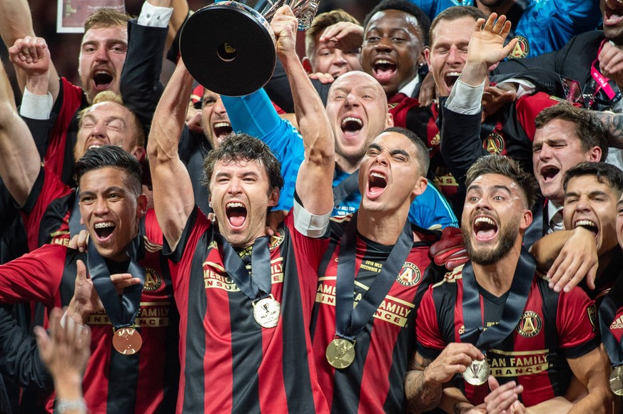 December 8, 2018 - Atlanta, Georgia, United States - Atlanta United defender and captain MICHAEL PARKHURST (3) lifts the MLS Fussball Herren USA Cup with teammates at Mercedes-Benz Stadium in Atlanta, ...