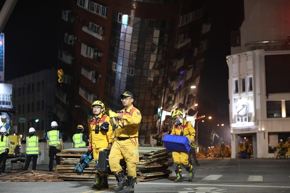 HUALIEN, CHINA - APRIL 03: Rescuers leave the site as the last remaining individual trapped in a severely tilted building was found after a 7.3-magnitude earthquake on April 3, 2024 in Hualien County, ...