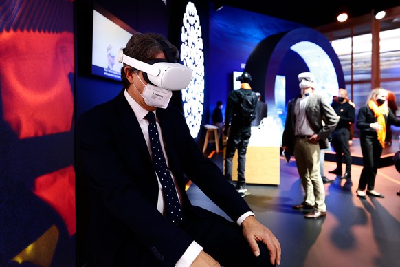 A congress attendant visiting the cathedral Notre Dame de Paris with the Meta Oculus Quest 2 headset on a virtual reality tour at the Orange stand during the Mobile World Congress (MWC) the biggest tr ...