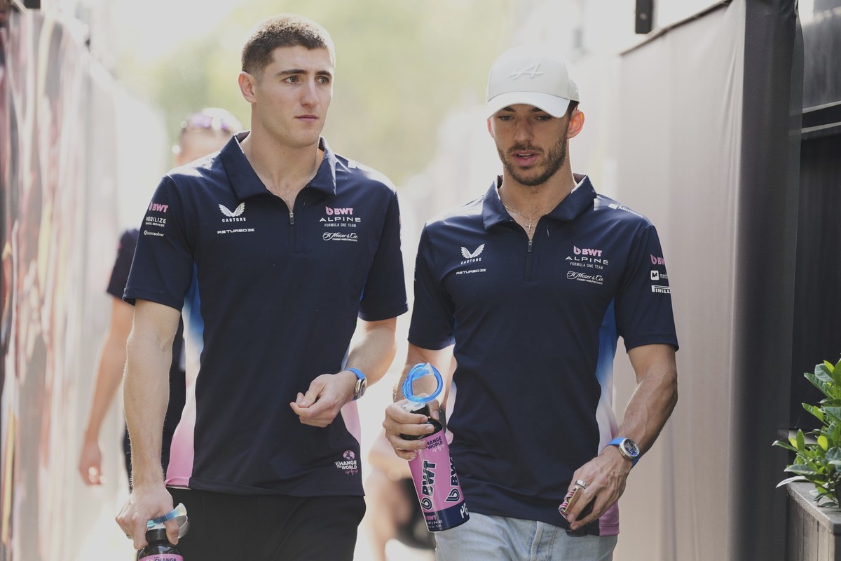 Alpine driver Jack Doohan, left, of Australia and teammate Pierre Gasly of France walk through the F1 paddock at the Australian Formula One Grand Prix at Albert Park, in Melbourne, Australia, Saturday ...