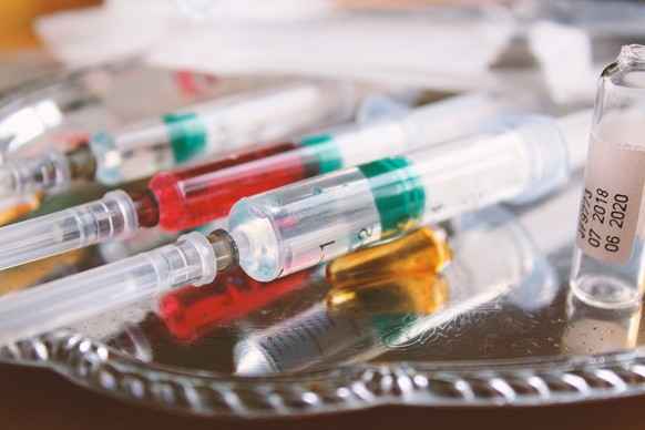 Syringes and ampoules on a tray. Close-up. Background.