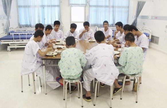 In this photo released by Thailand&#039;s Ministry of Health and the Chiang Rai Prachanukroh Hospital some of the rescued soccer team members eat a meal together in a hospital, Sunday, July 15, 2018,  ...