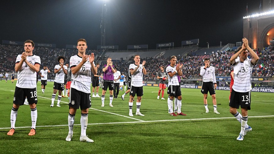 Italy fans make a touching gesture during the German anthem