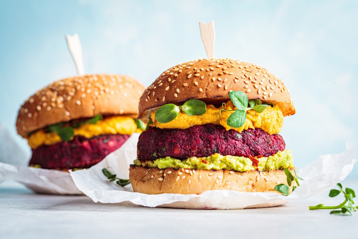 Vegan burger with beetroot cutlet, sweet potato sauce and guacamole.
