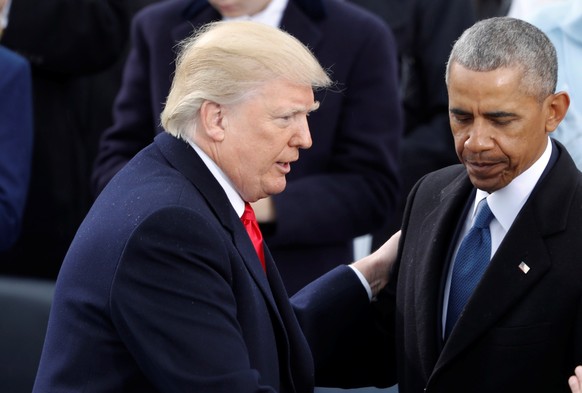 FILE PHOTO: U.S. President Donald Trump (L) greets former Vice President Joe Biden and former President Barack Obama after being sworn in as the 45th president of the United States on the West front o ...