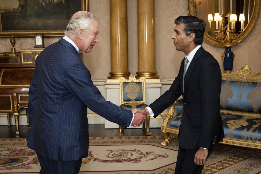 King Charles III welcomes Rishi Sunak during an audience at Buckingham Palace, London, where he invited the newly elected leader of the Conservative Party to become Prime Minister and form a new gover ...