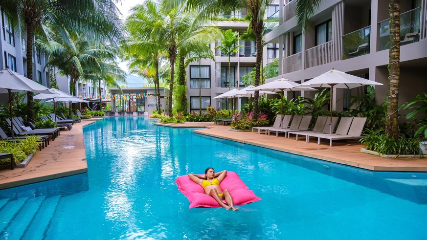 Asian Thai women relaxing on a floating matress in the swimming pool Asian Thai women relaxing on a floating mattress in the swimming pool during vacation Copyright: xZoonar.com/FokkexBaarssenx 193636 ...