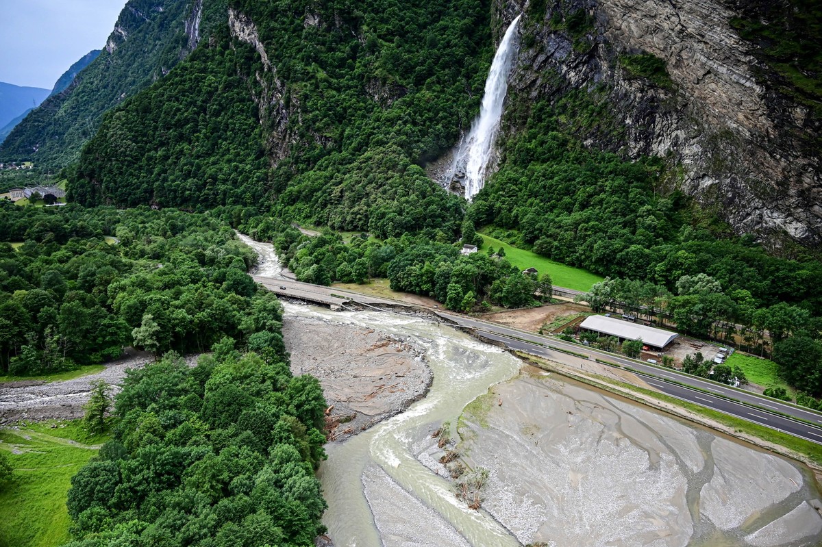 TOPSHOT - This aerial photograph shows a view of the A13 motorway section which collapsed in an area flooded by the Moesa river near Mesocco in the Graubunden (Grisons) canton in Switzerland on June 2 ...