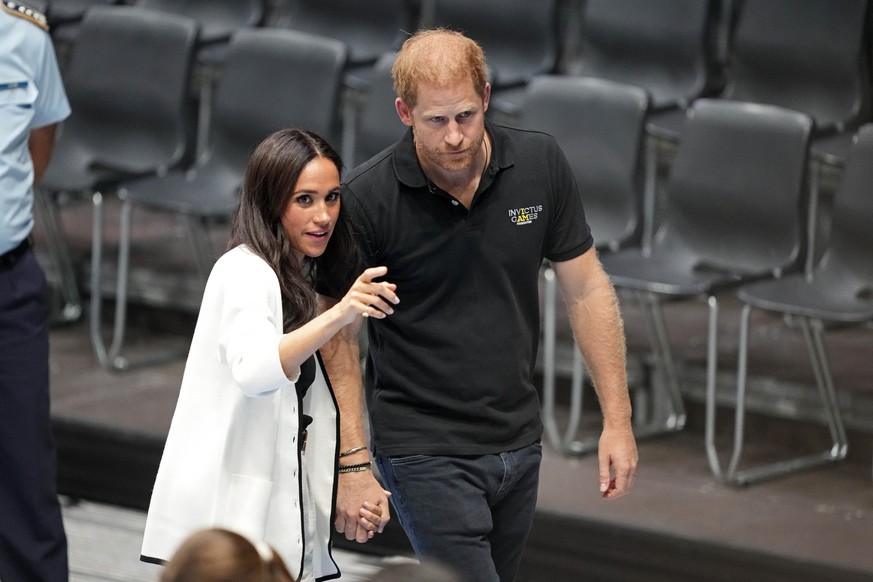 Britain&#039;s Prince Harry and Meghan, The Duke and Duchess of Sussex, walk on a court at the Invictus Games in Duesseldorf, Germany, Wednesday, Sept. 13, 2023. Harry founded the Invictus Games to ai ...