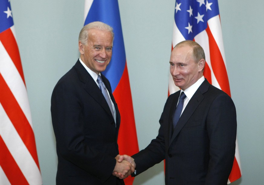FILE - In this March 10, 2011, file photo, then-Vice President Joe Biden, left, shakes hands with Russian Prime Minister Vladimir Putin in Moscow, Russia. Russia and the United States exchanged docume ...