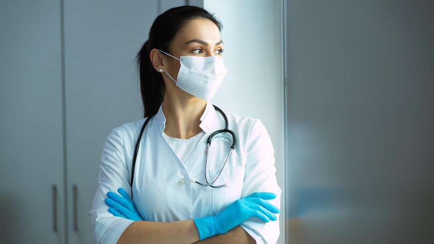 Caucasian pediatrician with stethoscope is waiting for patient stock photo. Pediatrics concept