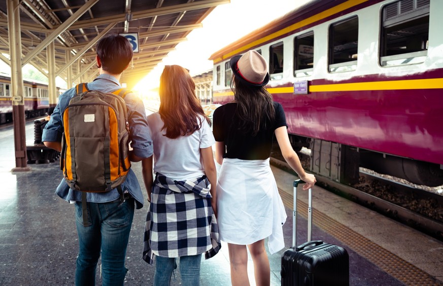 Group of tourist greeting and happiness after traveler by train and going to the city