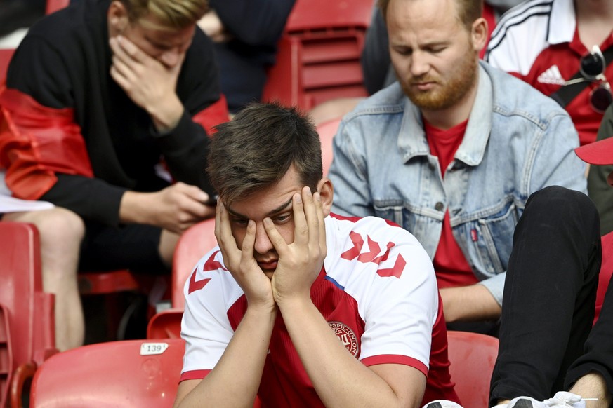 Fans react after Denmark&#039;s midfielder Christian Eriksen collapsed during UEFA Euro 2020 football tournament group B match Finland vs. Denmark at the Parken Stadium in Copenhagen, Denmark, on Satu ...