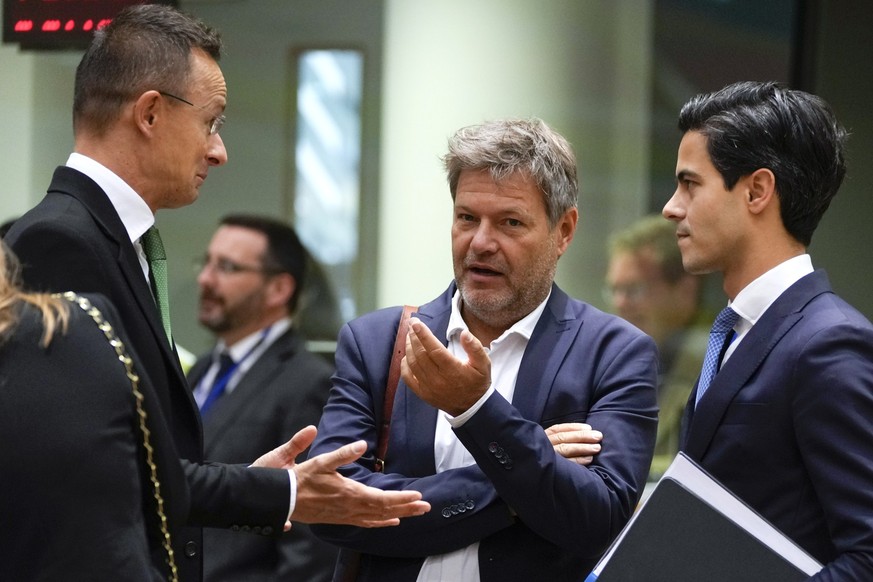 Germany Climate Action Minister Robert Habeck, center, speaks with Hungary's Foreign Minister Peter Szijjarto, left, and Netherland's Climate and Energy Minister Rob Jetten during a meeting of EU ener ...