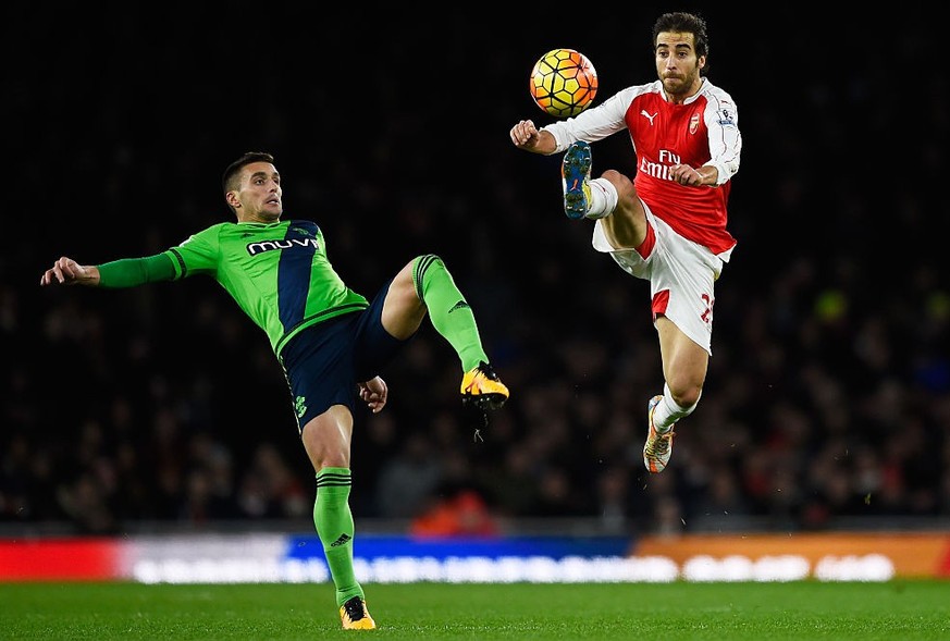 LONDON, ENGLAND - FEBRUARY 02: Mathieu Flamini of Arsenal and Dusan Tadic of Southampton compete for the ball during the Barclays Premier League match between Arsenal and Southampton at the Emirates S ...