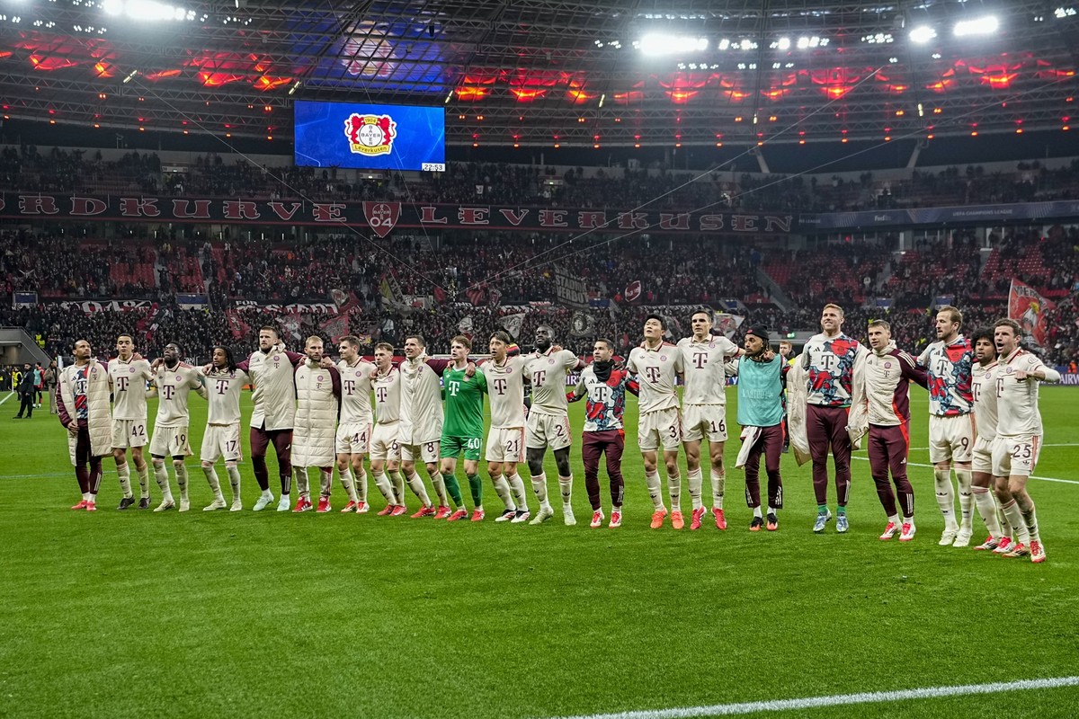 Bayern Munich players celebrate at the end of the Champions League round of 16 second leg soccer match between Bayer Leverkusen and Bayern Munich at the BayArena in Leverkusen, Germany, Tuesday, March ...