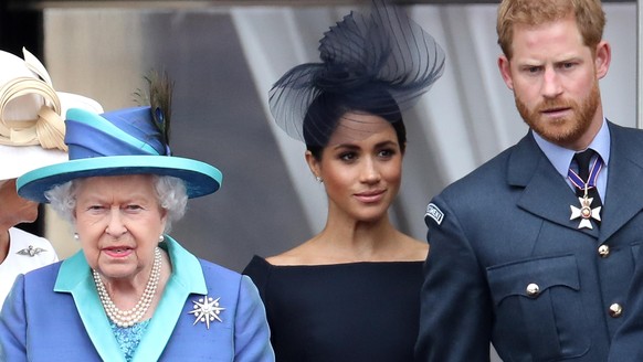 LONDON, ENGLAND - JULY 10: Queen Elizabeth II, Prince Harry, Duke of Sussex and Meghan, Duchess of Sussex on the balcony of Buckingham Palace as the Royal family attend events to mark the Centenary of ...