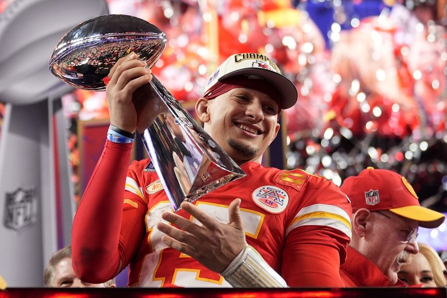 Kansas City Chiefs quarterback Patrick Mahomes celebrates with the trophy after the team&#039;s win in overtime during the NFL Super Bowl 58 football game against the San Francisco 49ers on Sunday, Fe ...