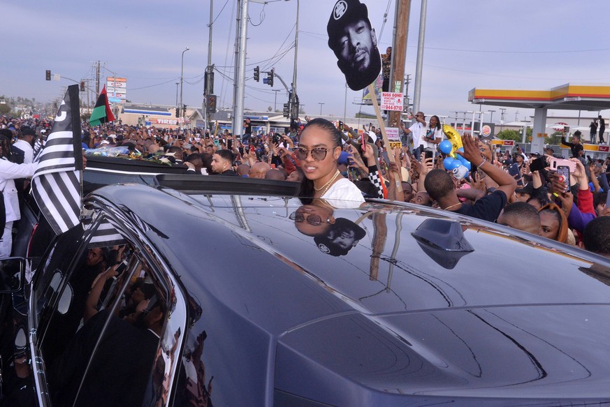 Nipsey Hussle s procession passes his Marathon Clothing store after his memorial at Staples Center in Los Angeles on April 11, 2019. The Grammy-nominated artist was killed last week in front of The Ma ...