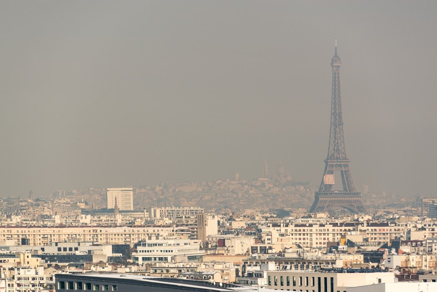 Aerial view of the Eiffel tower in the fog in Paris. City air pollution concept