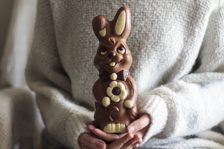 Woman hands holding big chocolate Easter bunny