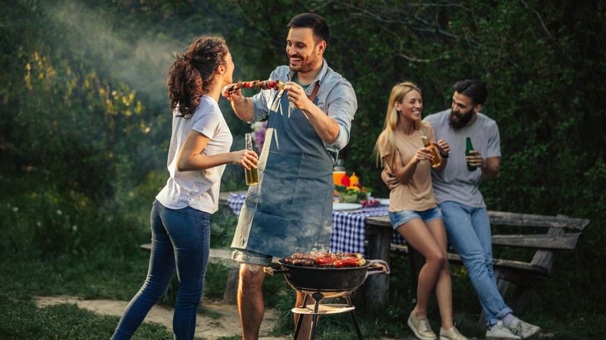 Group of friends having picnic in the park