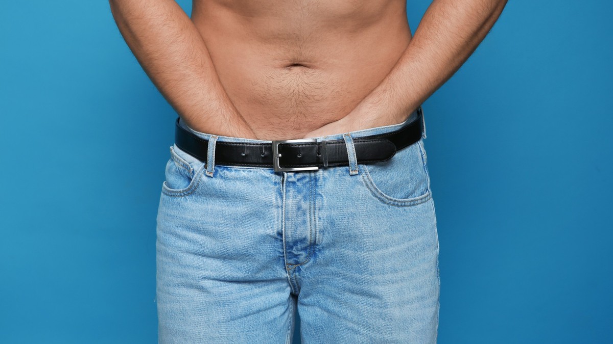 Man scratching crotch on color background, closeup. Annoying itch xkwx adult, allergic, allergy, annoying, background, blue, body, closeup, color, concept, crotch, dermatitis, dermatology, disease, ec ...