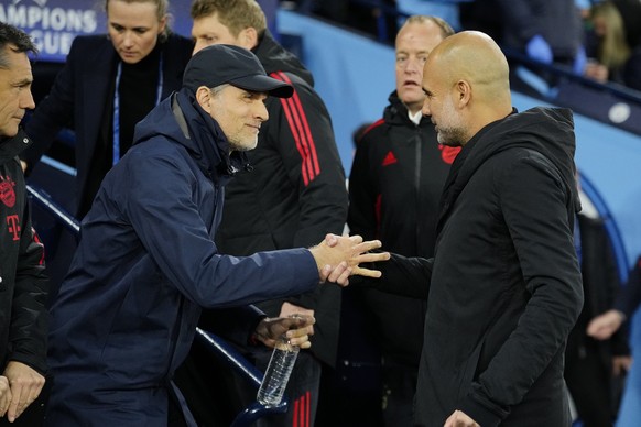 Manchester City&#039;s head coach Pep Guardiola, right, greets, Bayern&#039;s head coach Thomas Tuchel prior to the start of the Champions League quarterfinal, first leg, soccer match between Manchest ...