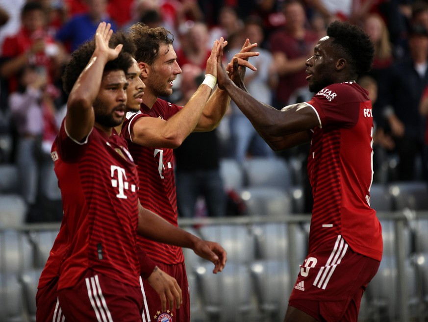 MUNICH, GERMANY - OCTOBER 03: Leon Goretzka of FC Bayern Muenchen celebrates with teammate Alphonso Davies after scoring their side&#039;s first goal during the Bundesliga match between FC Bayern Münc ...