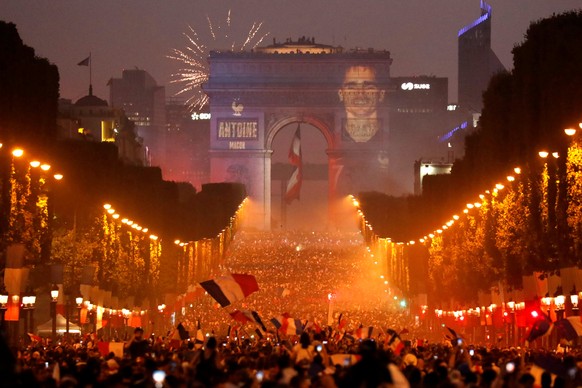 Soccer Football - World Cup - Final - France vs Croatia - Paris, France, July 15, 2018 - A giant picture of France&#039;s Antoine Griezmann is seen on the Arc de Triomphe as France fans celebrate on t ...
