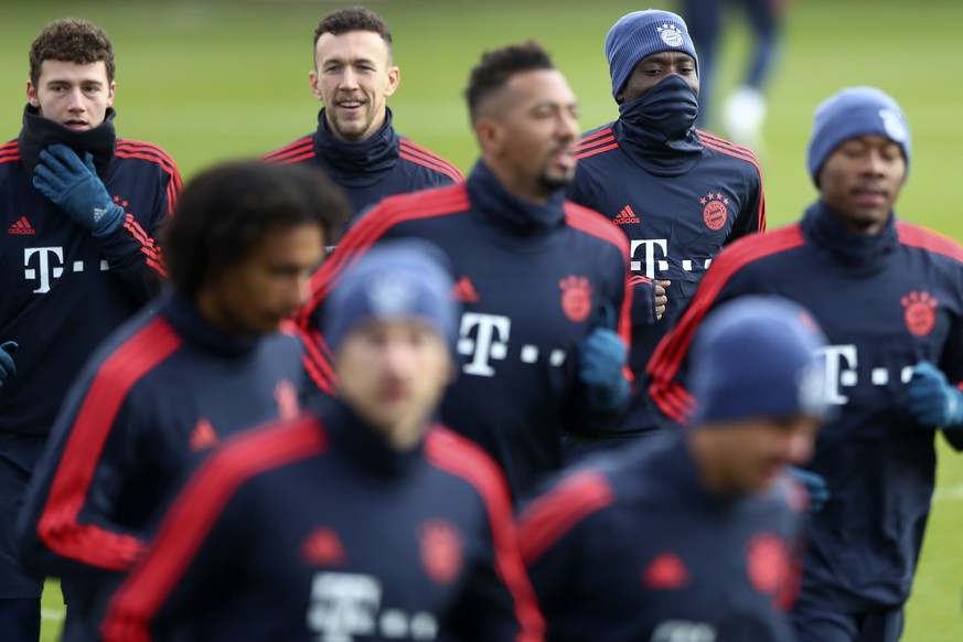 Bayern's Benjamin Pavard, background from left, Ivan Perisic and Alphonso Davies warm up for a training session in Munich, Germany, Tuesday, Dec. 10, 2019 prior to the Champions League group B soccer  ...