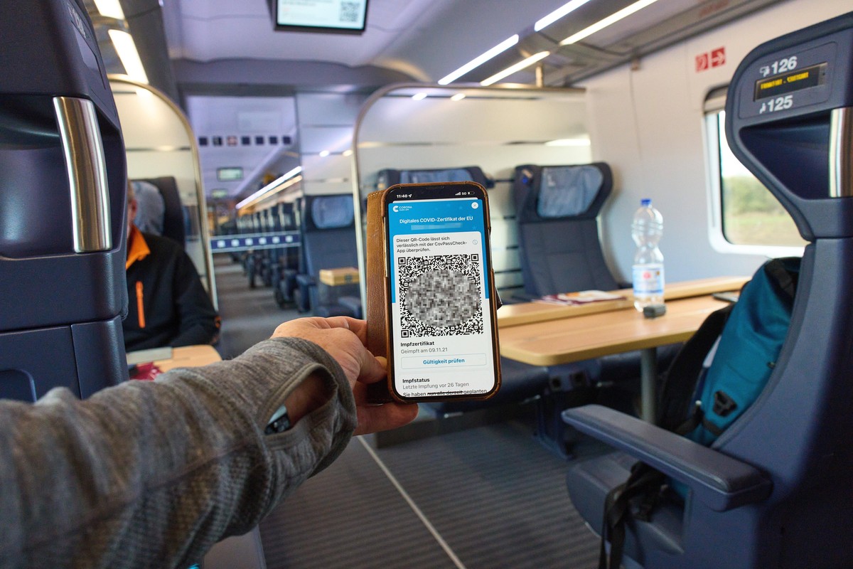 A passenger shows a Corona Warn App vaccination certificate in an Intercity train of Deutsche Bahn on Dec 5, 2021 in Frankfurt, Germany.