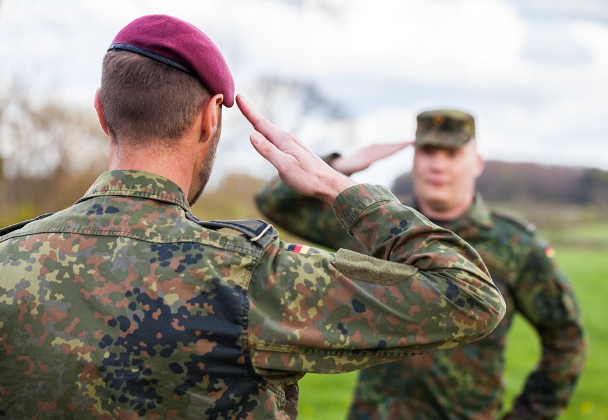 two german soldiers salute each other