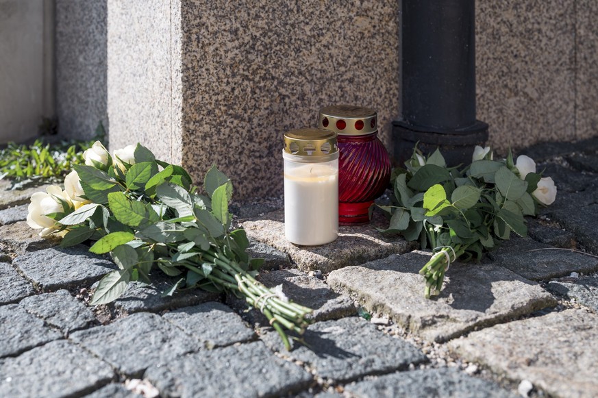 06.04.2023, Bayern, Wunsiedel: An der Straßenecke zur Zufahrtsstraße zum Kinder- und Jugendhilfezentrum, in dem eine Zehnjährige tot aufgefunden wurde, liegen Blumen und Grablichter auf dem Gehweg. Fo ...