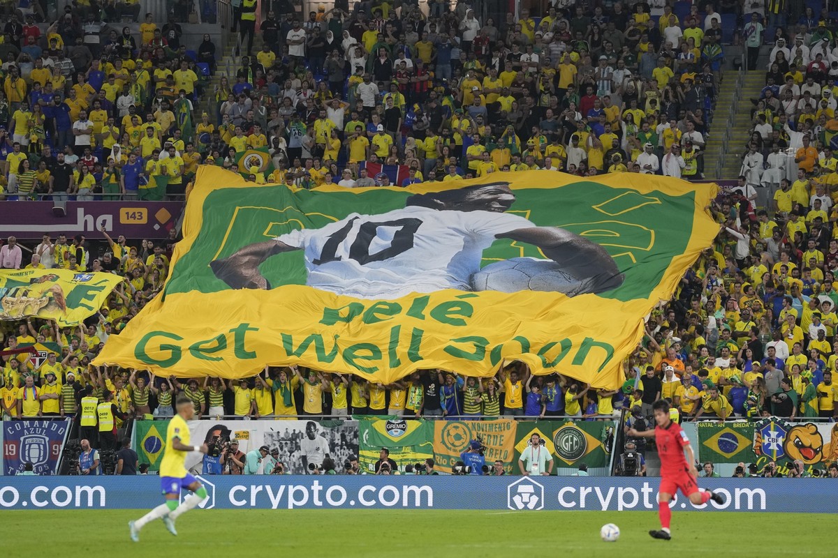 Brazilian fans hold a banner showing the Brazilian soccer legend Pele with the message &#039;Get well soon&#039; during the World Cup round of 16 soccer match between Brazil and South Korea at the Sta ...