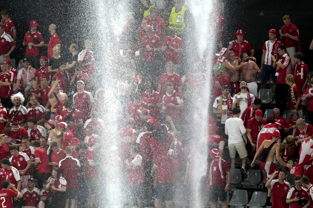 Heavy rain falls on the pitch after the referee paused the match due to a thunder and lightning storm during the round of sixteen match between Germany and Denmark at the Euro 2024 soccer tournament i ...
