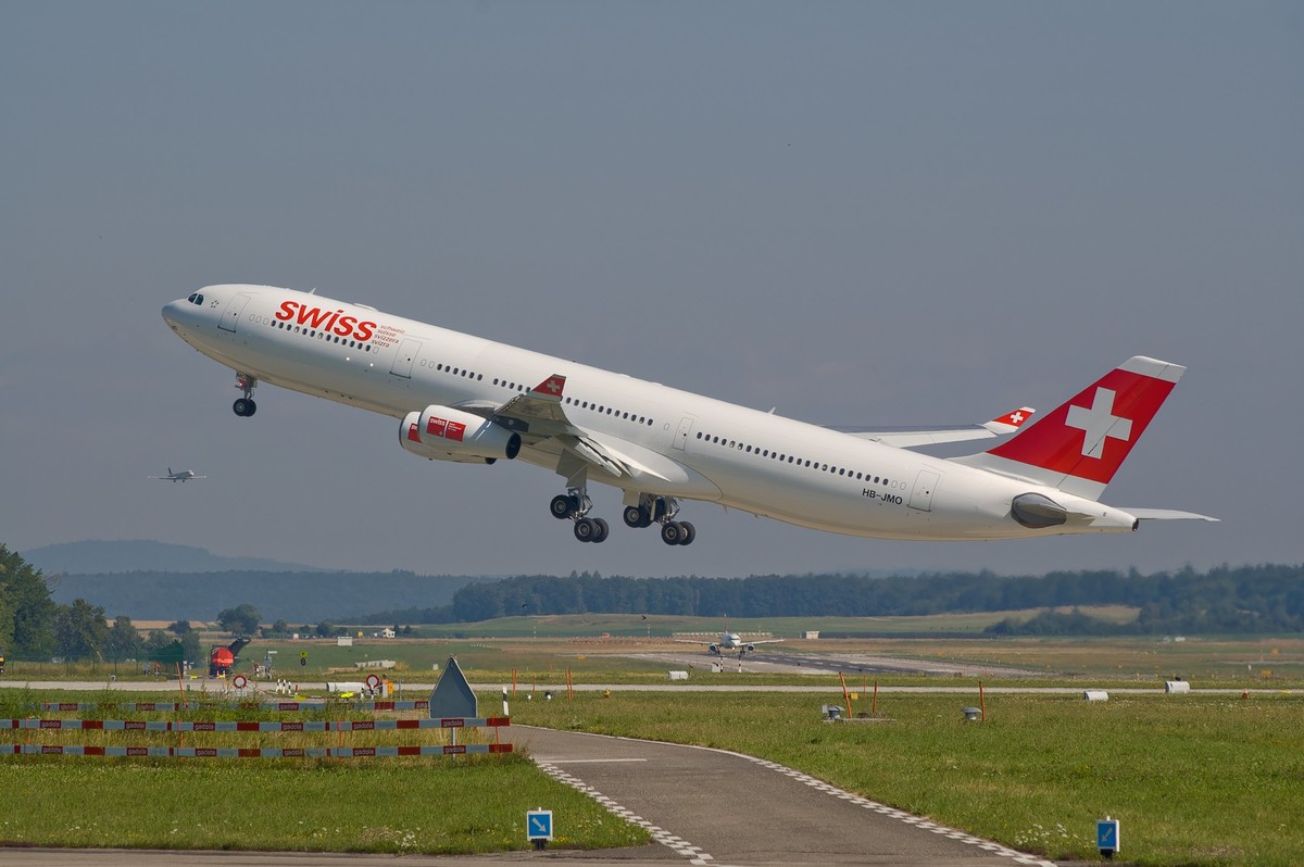 ZURICH, SWITZERLAND July 16, 2008: Swiss Airbus A340 is rocketing into the sky, ZURICH, SWITZERLAND: Swiss Airbus A340 is rocketing into the sky, ZURICH, SWITZERLAND: Swiss Airbus A340 is rocketing in ...