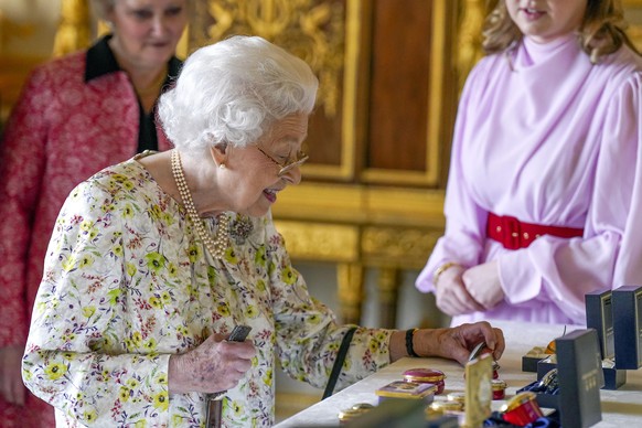 Queen Elizabeth II. Embargoed to 2230 Thursday March 24 Queen Elizabeth II views a display of artefacts from British craftwork company, Halcyon Days, to commemorate the company's 70th anniversary in t ...