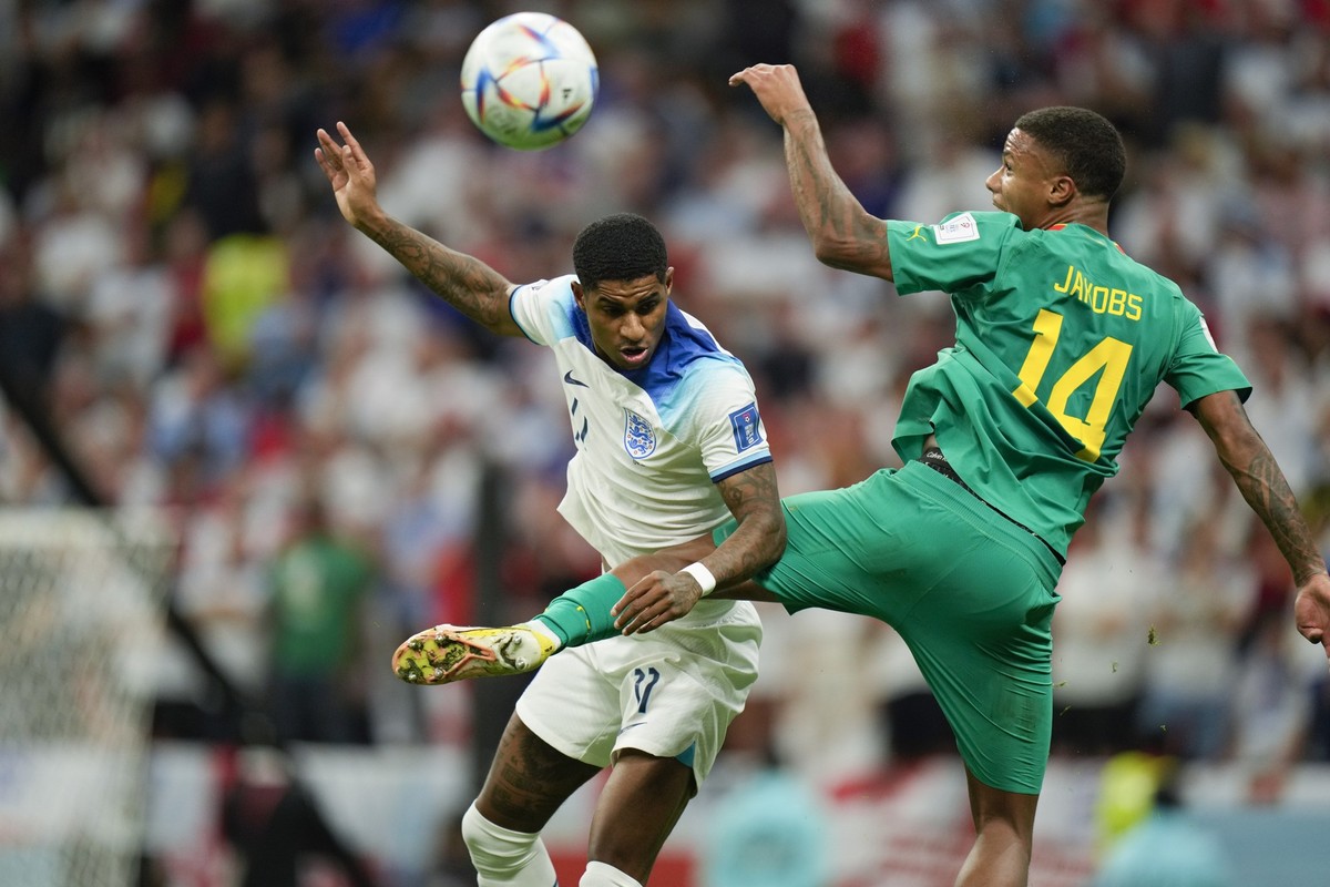 England's Marcus Rashford, left, andSenegal's Ismail Jakobs go for a header during the World Cup round of 16 soccer match between England and Senegal, at the Al Bayt Stadium in Al Khor, Qata ...