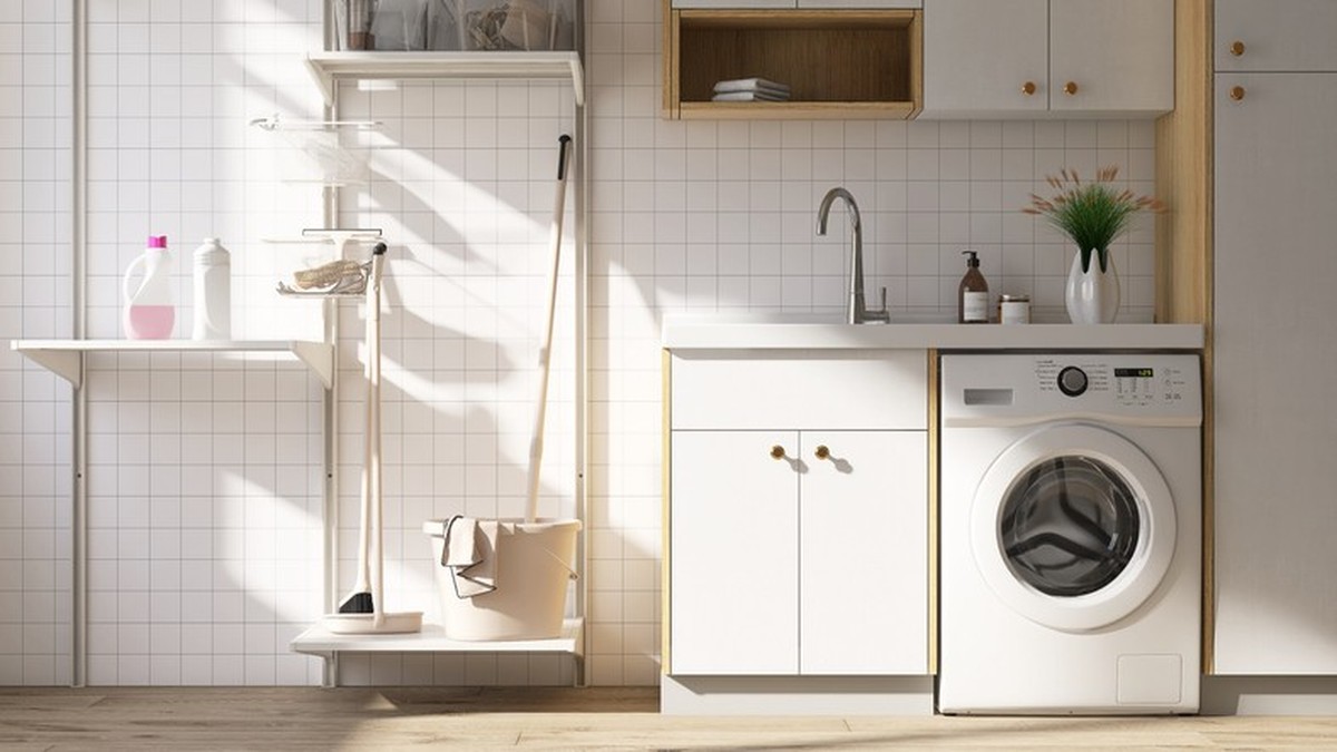 Modern and luxury design of laundry room with washing machine, counter, cabinet and cleaning equipment on parquet floor with sunlight from window on white mosaic wall for cleaning and washing product ...