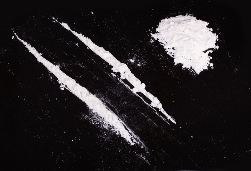 cocaine powder in lines on a black background