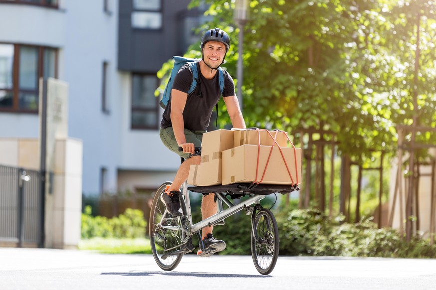 Bicycle messenger making a delivery on a cargo bike