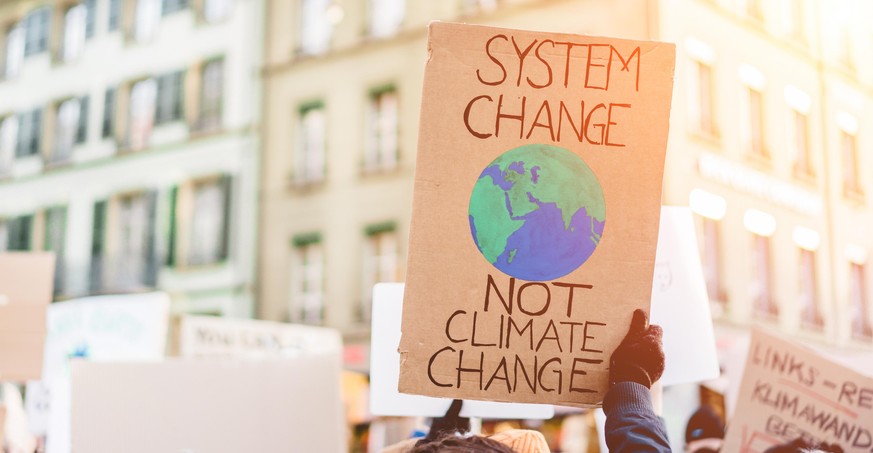 Group of demonstrators on road, young people fight for climate change - Global warming and enviroment concept - Focus on banner