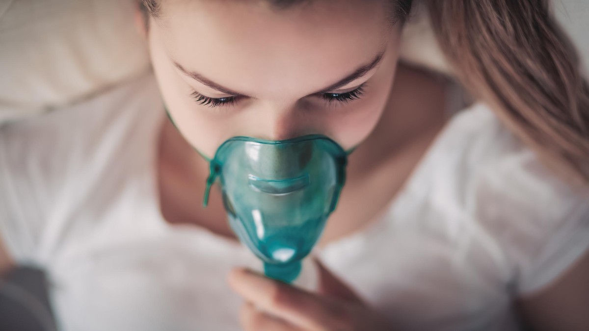 Young woman in a process of healing. Daily asthma care. Very Shallow DOF. Developed from RAW; retouched with special care and attention; Small amount of grain added for best final impression.
