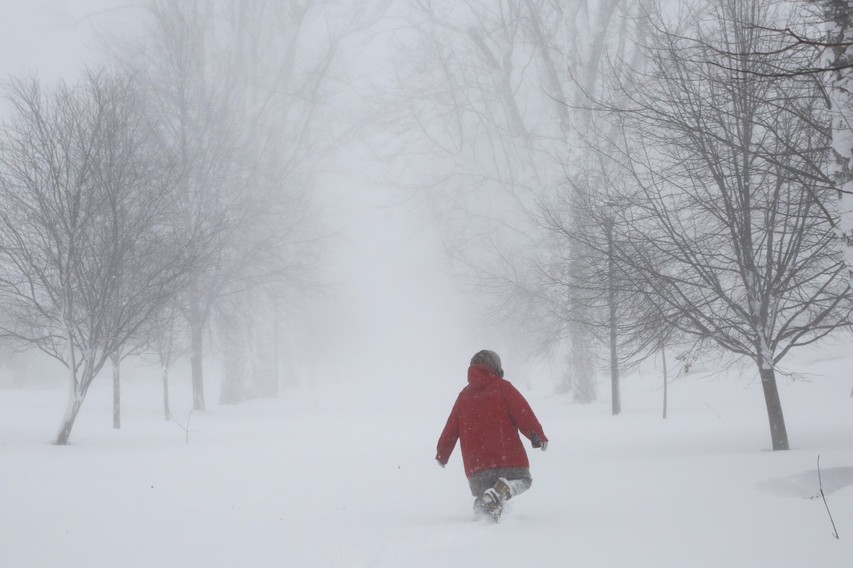 24.12.2022, USA, Amherst: Ein Mensch läuft durch Schneemassen. Ein heftiger Wintersturm hat am Samstag Hunderttausende von Haushalten und Unternehmen in den Vereinigten Staaten von Amerika von der Str ...