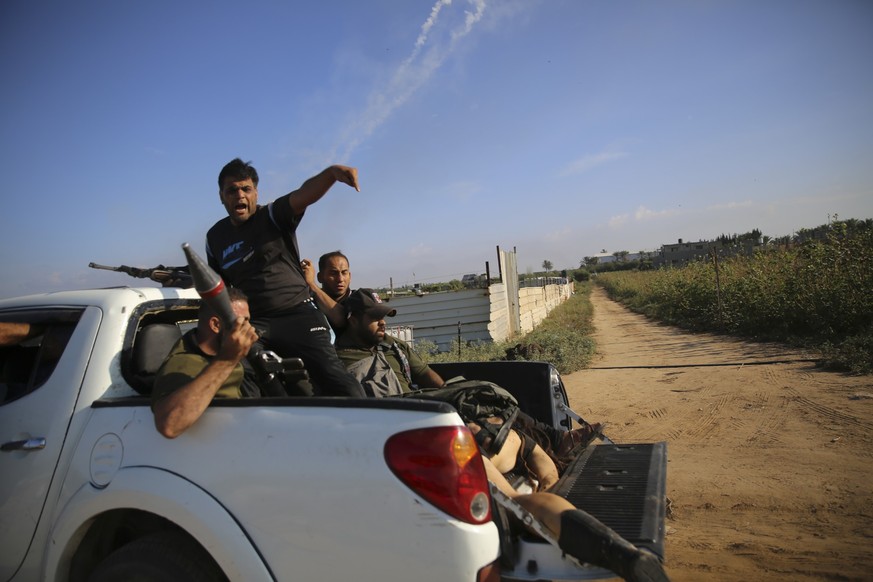 Palestinian militants drive back to the Gaza Strip with the body of Shani Louk, a German-Israeli dual citizen, on Saturday, Oct. 7, 2023. The militant Hamas rulers of the Gaza Strip carried out an unp ...